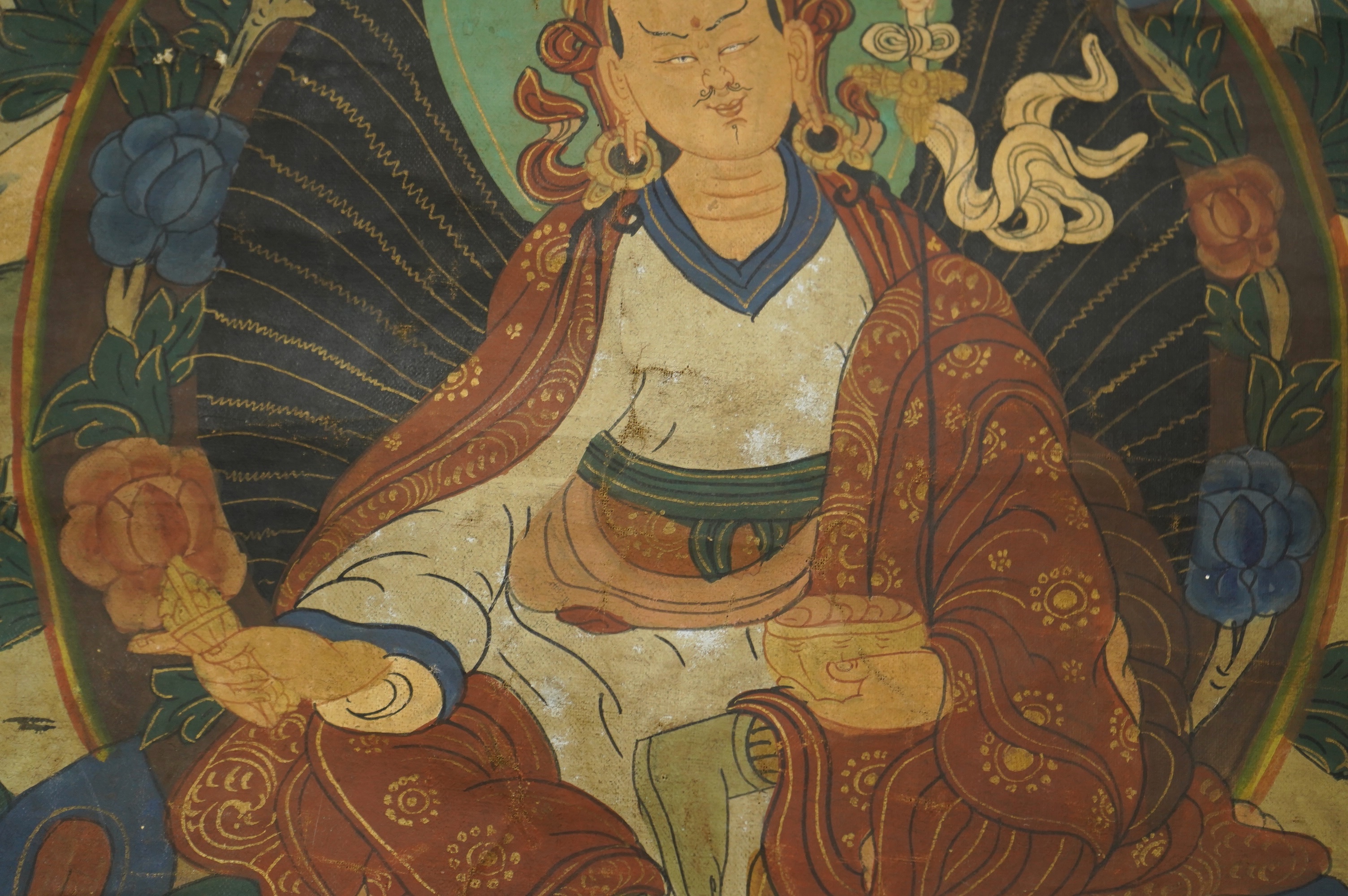 A Tibetan painted silk thangka, depicting Padmadambhara seated on a throne of lotus petals, 19th century